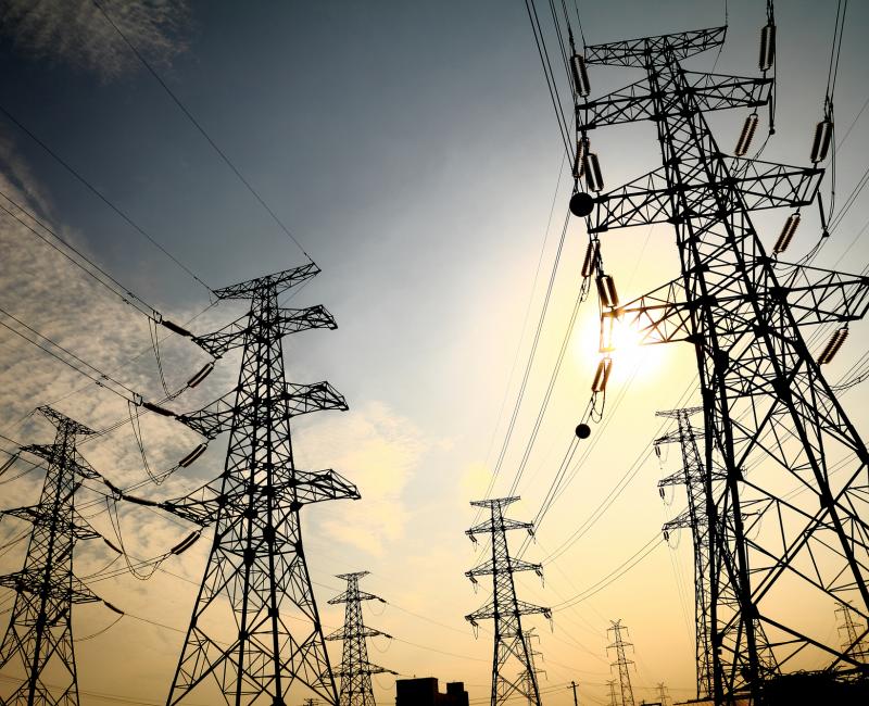 Power transmission towers in sunset