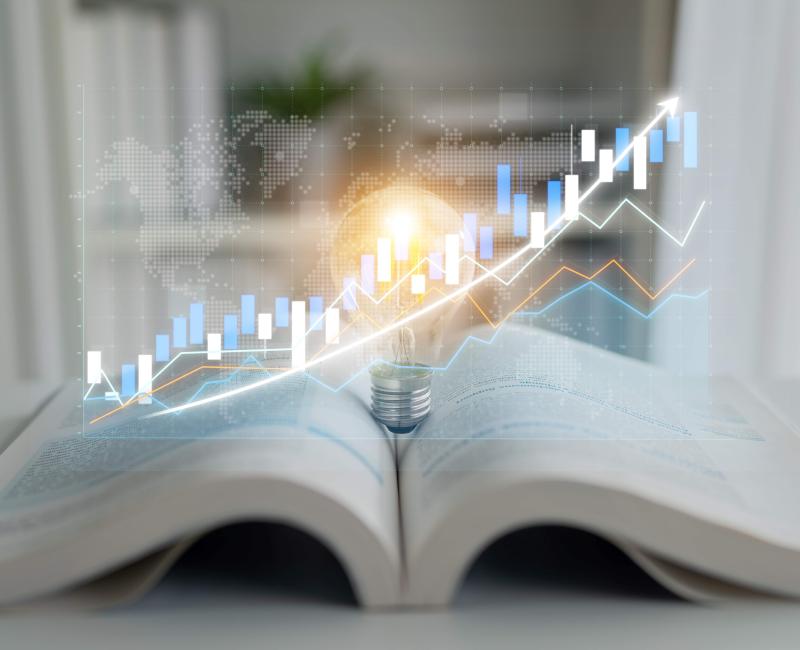 Light bulb and data trends on open book
