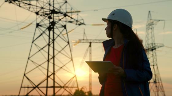 Woman engineer checking electrical pylons